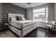 Bright bedroom with a luxurious white upholstered bed and a large window with a city view at 333 Massachusetts Ave # 801, Indianapolis, IN 46204