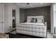 Stylish bedroom with a statement chevron wall, a plush white bed, and dark wood flooring at 333 Massachusetts Ave # 801, Indianapolis, IN 46204