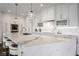 Bright kitchen with white cabinets, marble countertops, large island, and stainless steel appliances at 333 Massachusetts Ave # 801, Indianapolis, IN 46204