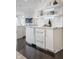 Sleek, modern kitchen with white marble countertops and backsplashes, complemented by stylish light fixtures and open shelving at 333 Massachusetts Ave # 801, Indianapolis, IN 46204