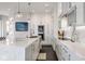 Bright kitchen with white cabinets, marble countertops, a large island, and modern appliances at 333 Massachusetts Ave # 801, Indianapolis, IN 46204
