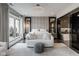 Bright, luxurious bedroom with a plush seating area, city views, and a glimpse into an elegant en-suite bathroom at 333 Massachusetts Ave # 801, Indianapolis, IN 46204