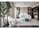 Spacious bedroom featuring elegant decor, sitting area, large windows, and ample natural light and hardwood floors at 333 Massachusetts Ave # 801, Indianapolis, IN 46204