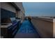 Rooftop deck featuring a shuffleboard court, outdoor kitchen with grill, and a stunning cityscape backdrop at 333 Massachusetts Ave # 801, Indianapolis, IN 46204