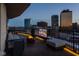 Relaxing rooftop deck with comfy seating, a fire pit, and mounted television, perfect for entertaining at 333 Massachusetts Ave # 801, Indianapolis, IN 46204