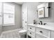 Bright bathroom featuring modern vanity, marble countertop, patterned tile floor, and window with blind at 342 E Minnesota St, Indianapolis, IN 46225