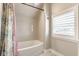 Bathroom featuring a white bathtub with shower, subway tile and patterned curtain at 342 E Minnesota St, Indianapolis, IN 46225