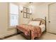 Cozy bedroom with a comfortable bed, floral-themed blanket, and stylish wall sconces at 342 E Minnesota St, Indianapolis, IN 46225