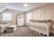 Bedroom featuring a crib with floral accents, a comfortable chair, and plenty of storage space at 342 E Minnesota St, Indianapolis, IN 46225