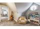 Playroom with a unique octagonal window and a cozy bear chair with an array of colorful books and toys at 342 E Minnesota St, Indianapolis, IN 46225