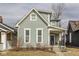 Charming home featuring light-green siding, white trim, and a quaint covered front porch at 342 E Minnesota St, Indianapolis, IN 46225