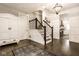 Elegant foyer with hardwood floors, staircase, coat closet, and decorative lighting at 342 E Minnesota St, Indianapolis, IN 46225