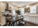 Modern kitchen features white cabinets, stainless steel appliances, and a dining table at 342 E Minnesota St, Indianapolis, IN 46225