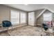Bright home office with natural light, two windows, neutral walls, colorful rug, and a comfortable office chair at 342 E Minnesota St, Indianapolis, IN 46225