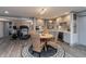 Basement kitchenette with gray cabinets, modern appliances, and a cozy dining area at 3982 Abbotsford Dr, Westfield, IN 46074