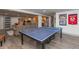 Basement game room with a ping pong table, entertainment area, and kitchenette at 3982 Abbotsford Dr, Westfield, IN 46074