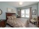 Comfortable bedroom with a patterned bedspread, wood furnishings, and a window with natural light at 3982 Abbotsford Dr, Westfield, IN 46074