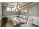 Formal dining room with wainscoting, elegant chandelier, and a decorative table runner at 3982 Abbotsford Dr, Westfield, IN 46074