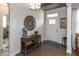 Inviting entryway with hardwood floors, decorative mirror, console table, and bright white front door at 3982 Abbotsford Dr, Westfield, IN 46074