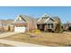 Beautifully landscaped brick home boasting an attached garage, mature trees, and cozy front porch at 3982 Abbotsford Dr, Westfield, IN 46074