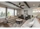 Bright living room with a ceiling fan, hardwood floors, a patterned rug, and comfortable seating at 3982 Abbotsford Dr, Westfield, IN 46074