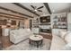 Open-concept living room featuring a fireplace, built-in shelving, a gray rug, and hardwood floors at 3982 Abbotsford Dr, Westfield, IN 46074