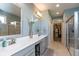 Modern main bathroom featuring dual sinks, stylish mirrors, and tile flooring at 3982 Abbotsford Dr, Westfield, IN 46074