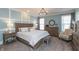 Spacious main bedroom with a wooden bed frame, a seating area, and natural light at 3982 Abbotsford Dr, Westfield, IN 46074