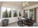 Screened-in patio with seating area, ceiling fan, and view of backyard, perfect for relaxing and entertaining guests at 3982 Abbotsford Dr, Westfield, IN 46074