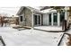A backyard deck covered in snow with siding and a door at 5937 Broadway St, Indianapolis, IN 46220