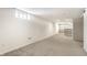 Large open carpeted area of a finished basement with white walls and small windows at 5937 Broadway St, Indianapolis, IN 46220