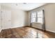 This bedroom has hardwood floors, two large windows and a neutral paint scheme at 5937 Broadway St, Indianapolis, IN 46220