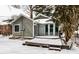 Exterior of home featuring a snow-covered deck and partially enclosed sunroom at 5937 Broadway St, Indianapolis, IN 46220