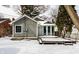 Home exterior with snow covered deck, a sunroom, and attractive siding at 5937 Broadway St, Indianapolis, IN 46220