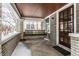 Inviting covered front porch featuring brick columns, a porch swing, and a warm welcome at 5937 Broadway St, Indianapolis, IN 46220