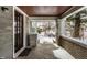 Inviting covered front porch with brick columns, concrete floor, and a view of the neighborhood at 5937 Broadway St, Indianapolis, IN 46220