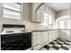 Kitchen with white appliances, butcher block countertops, and black and white checkered floors at 5937 Broadway St, Indianapolis, IN 46220