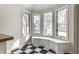 Breakfast nook featuring a black and white checkered floor, bay window and a built in bench seat at 5937 Broadway St, Indianapolis, IN 46220