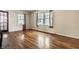 Open living room with hardwood floors and bright window views at 5937 Broadway St, Indianapolis, IN 46220