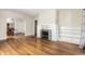 Spacious living room featuring gleaming hardwood floors, an archway, and a classic white fireplace at 5937 Broadway St, Indianapolis, IN 46220