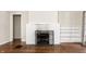 Classic living room with white brick fireplace and beautiful hardwood flooring at 5937 Broadway St, Indianapolis, IN 46220