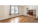 Bright living room featuring hardwood floors, a window, and an archway to a dining area at 5937 Broadway St, Indianapolis, IN 46220