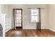 Bright living room with hardwood floors, a white fireplace, and natural light at 5937 Broadway St, Indianapolis, IN 46220