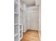 A walk-in closet with white shelving and hardwood floors provides ample storage space at 5937 Broadway St, Indianapolis, IN 46220