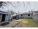 Spacious backyard with gray home exterior, deck, and outdoor fire pit at 6047 Guilford Ave, Indianapolis, IN 46220