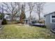 Backyard showing deck, shed, patio with chairs, and green grass at 6047 Guilford Ave, Indianapolis, IN 46220