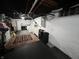 Finished basement area with an area rug, bed and storage space at 6047 Guilford Ave, Indianapolis, IN 46220