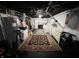 Finished basement area with an area rug, bed and storage space at 6047 Guilford Ave, Indianapolis, IN 46220