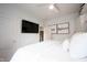 Bedroom view showing door and mounted flat screen TV at 6047 Guilford Ave, Indianapolis, IN 46220