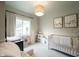 Bedroom features crib, chair, area rug, and modern decor at 6047 Guilford Ave, Indianapolis, IN 46220
